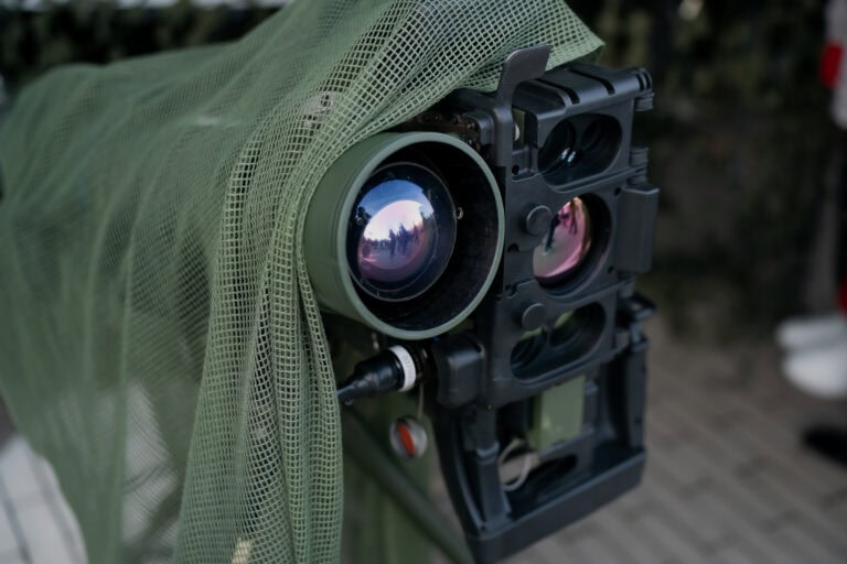 Military optical surveillance and targeting system with camouflaged netting
